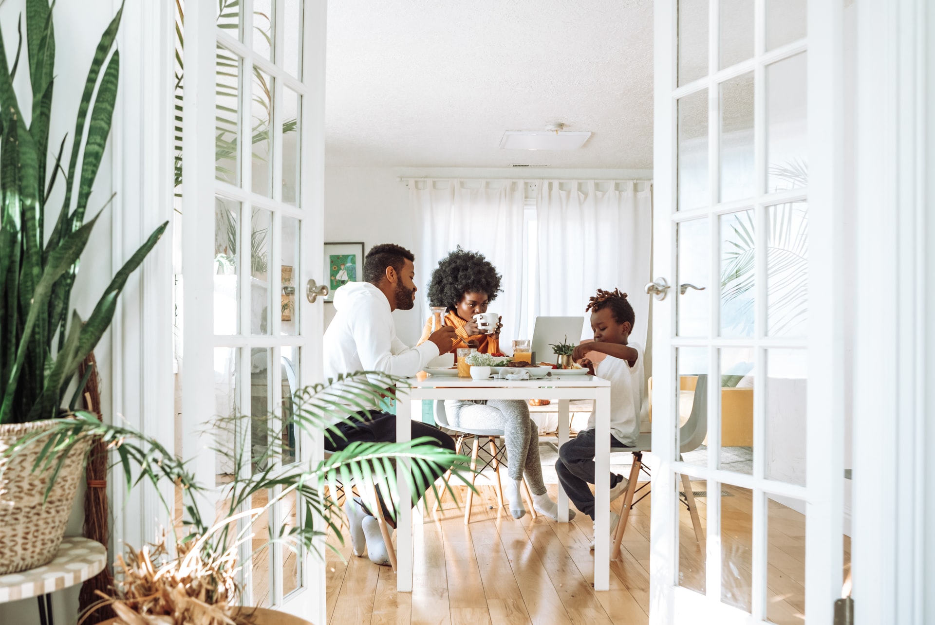 African-American family dines at home in suburban neighborhood