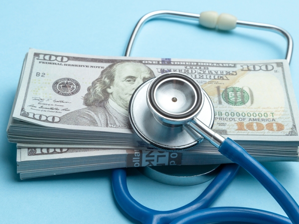 Stethoscope on stack of U.S. $100 bills