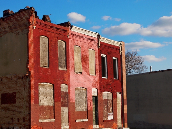 Abandoned block of rowhouses against a blue sky
