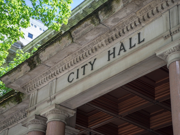 City hall exterior with the words "city hall" above entryway