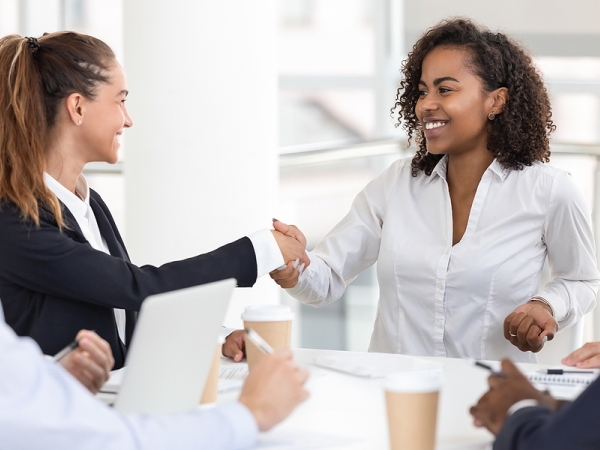 Woman congratulates another woman after being hired