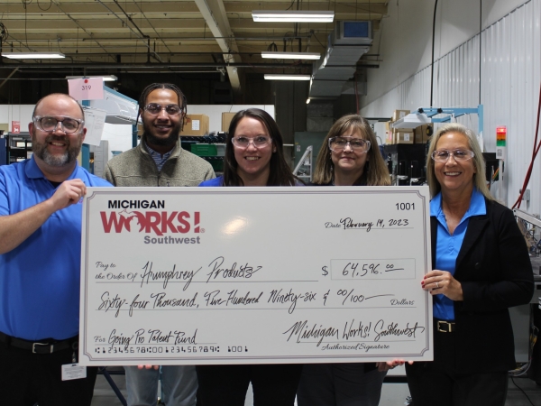 Kevin Delancey, far left, and Laura Oliver, far right, both of Humphrey Products, receive a check for the Going PRO Talent fund from Michigan Works! Southwest's Devon Ivy, Ashley Iovieno and Jessica Meskil. 