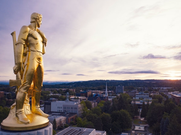 The golden pioneer atop the Capitol building looks at a sunset over Salem, Oregon. 