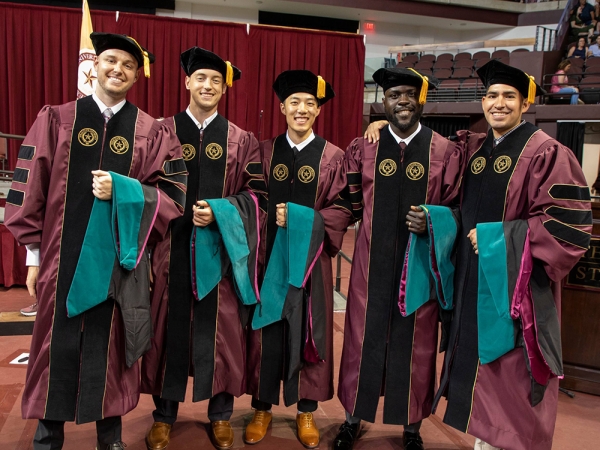 Graduate degree recipients pose