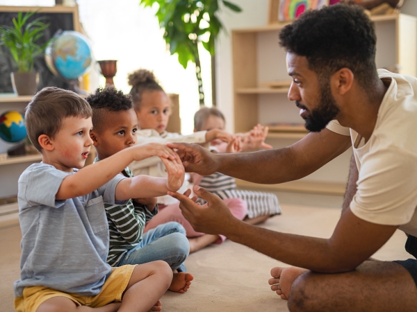 Child care teacher works with children